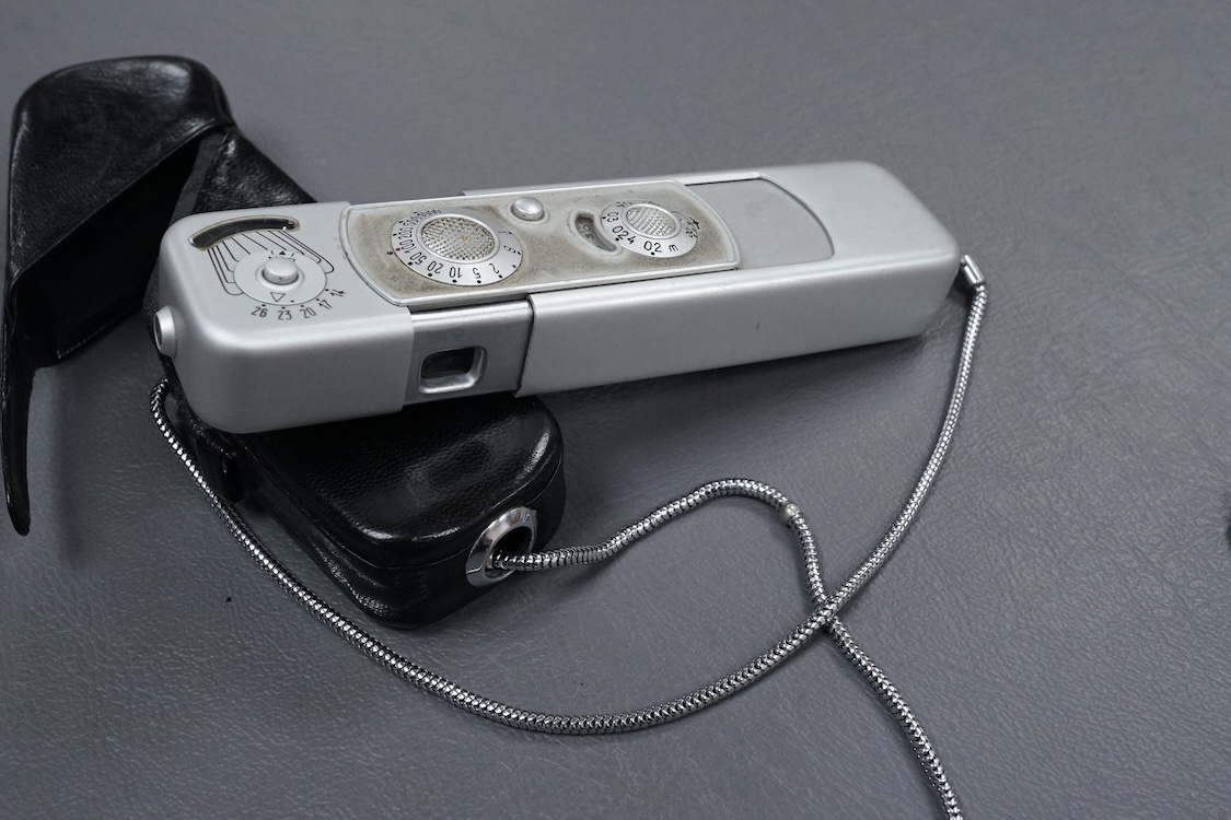 A Minolta Minox miniature camera Model B, in its original leather case with metal lanyard.